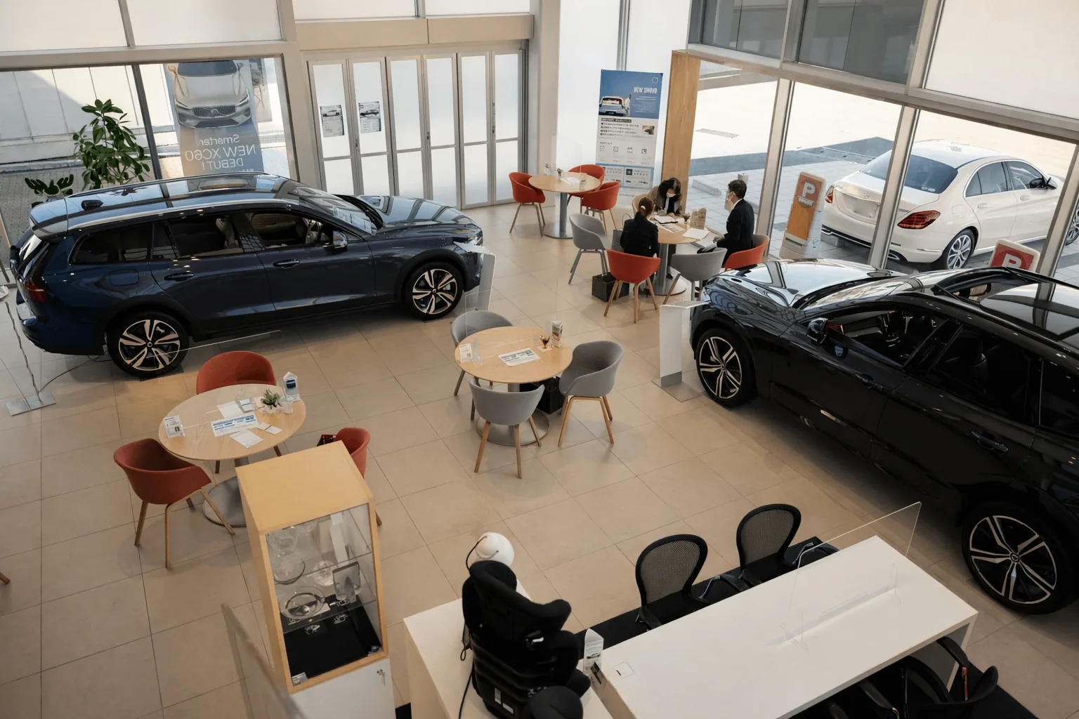 Professional automotive dealership team discussing business strategy in a modern office